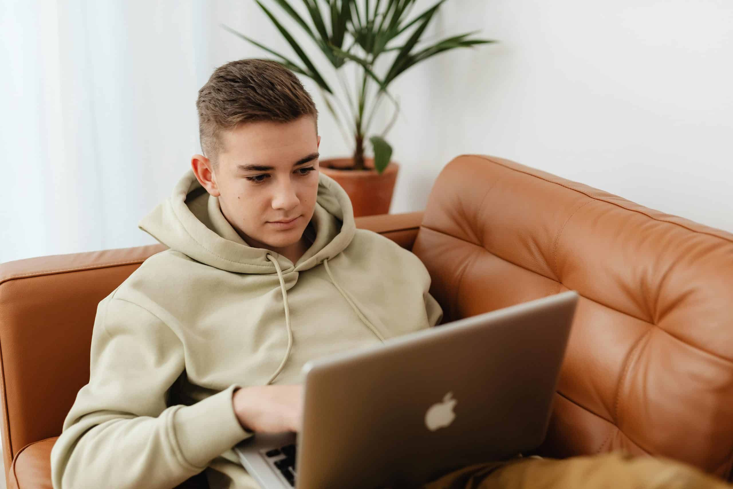 Teenager on laptop studying NEC's Structured GCSE Programme